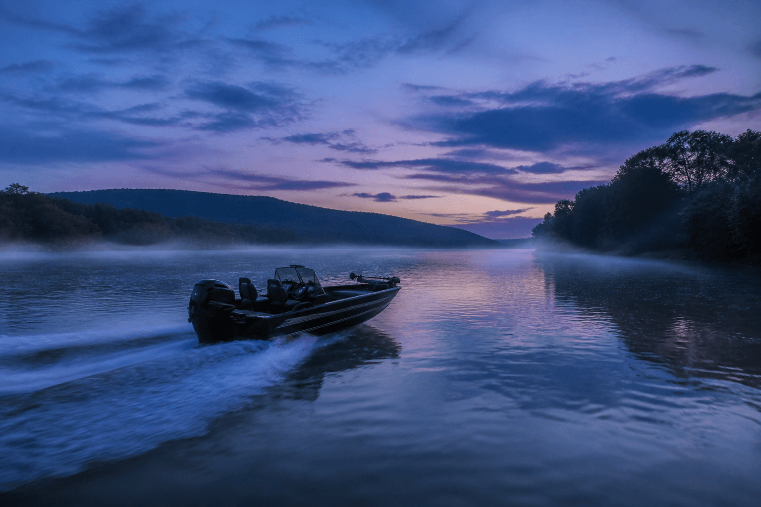 Aluminum boat wake on a Tennessee river at dusk